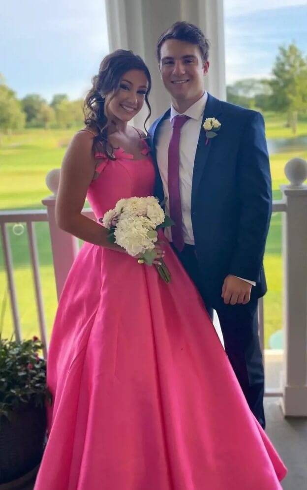 Сouple wearing a pink gown and a black suit